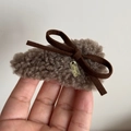 Detail of plush brown hair clip with suede bow and engraved gold metal charm - Gray with Bowknot