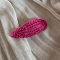 Close-up of handmade wavy edge wool knit hair clip in vibrant magenta pink color - Deep Pink