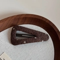 Detailed view of a brown polka dot woolen fabric triangle hair clip on a wood tray - Coffee Polka Dot Hollow Large Triangle