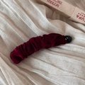 Close-up of a burgundy velvet banana hair clip with elegant pleats on soft fabric - Velvet Pleated Banana Clip / Burgundy