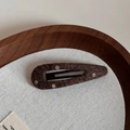 Detailed shot of dark brown polka dot knitted hair clip on a minimalist canvas background - Coffee Polka Dot Hollow Drop
