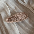 Close-up of handmade wavy wool knit BB clip showing light brown yarn texture details - Beige
