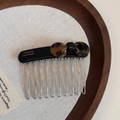 Close-up of tortoise shell bow hair comb with ten metal teeth and handmade engraving - Black Tortoise Shell