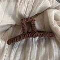 Detail shot of brown knitted yarn-wrapped shark clip on textured cream linen background - Coffee Striped - Large Claw Clip