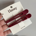 Details von weinroten Haarspangen mit mattem und glänzendem Finish auf einer Karte - Hohle Haarklemmen - Rot