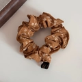 Dettaglio di un elastico per capelli marrone a fiori con etichetta nera Korea - Floreale Giallo