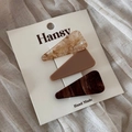 Detailed set of three acetate hair clips in marble and tortoise patterns on display card - Triangle Style