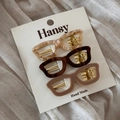 Detailed set of three eyewear-shaped acetate hair clips in varied colors on display card - Sunglasses Style