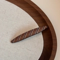 Close-up of a large brown striped hair claw clip on a rustic linen and wooden surface - Matte Stripe-Willow Leaf Barrettes / Coffee