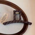 Close-up of a large brown hair claw clip with blue stripes on a wooden tray - Matte Stripe-Fine Straight Claw / Brown