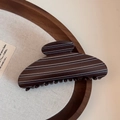 Detail of large brown striped shark hair claw clip on aesthetic wooden tray - Matte Stripe-Fan-shaped Claw / Brown