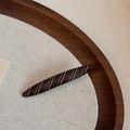 Close-up of a large wood-textured hair claw clip with cream diagonal stripes on a wooden tray - Matte Stripe-Willow Leaf Barrettes / Brown