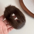 Detail view of a large brown faux mink fur hair clip with soft plush texture in hand - Dark Brown (FJ89827)