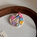 Macro shot of handcrafted crochet painter's palette hair clip with colorful wool details - Handmade Crochet BB-Palette