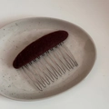Detail view of the brown felt texture and ten-tooth silver metal hair comb pin - Oval Fabric Comb-Brown