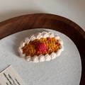 Detailed macro of a crochet strawberry tart hair clip with soft woven textures - Handmade Crochet BB-Orange Apple