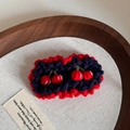 Detailed macro view of handmade crochet cherry hair clips with red and blue knit textures - Handmade Crochet BB-Double Cherry