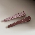Detail of two acetate hair clips featuring contrast patterns with dots and zigzags - Pink Series Duckbill Clip Pair