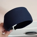 Detailed close-up showing the navy blue striped fabric texture of a wide knitted headband - Navy Blue