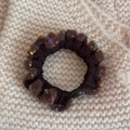 Detailed view of a brown pleated hair scrunchie with colorful yarn trim on a knit background - Basic Style / Brown