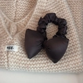 Detailed close-up of a black satin bow scrunchie on a beige knitted background texture - Coffee (Filled Bow Style)