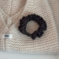 Detailed view of coffee brown satin scrunchie with white stitching on knit background - Coffee (Dotted Edge Style)