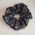 Detail of blue plaid fabric scrunchie with a brown flocked bear charm and white label - Grey Brown Plaid Bear Scrunchie