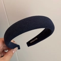 Detail of a thick navy blue fabric headband featuring a handmade inner woven label - Basic Padded Headband / Navy Blue
