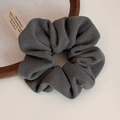 Detail of dark grey textured fabric hair scrunchie with thick pleats and soft woven finish - Textured Scrunchie / Gray
