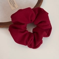 Close-up of burgundy fabric scrunchie with soft pleated texture on vintage wooden tray - Textured Scrunchie / Red
