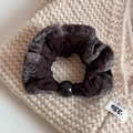 Detailed close-up of brown plush scrunchie with grey velvet trim and a black bead accent - Brown