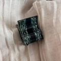 Detailed macro view of small square acetate claw clip with dark green marble pattern texture - Dark Green