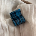 Detailed macro view of the small square blue acetate hair claw clip with black marbled pattern - Blue Tiger Stripe