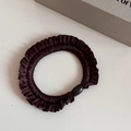 Detailed texture of dark brown pleated hair tie with elegant glossy oval bead accessory - Brown