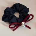 Detailed close-up of a black fabric scrunchie with red velvet bow and pearl charm - Pearl Bowknot-Black
