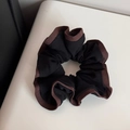 Detailed shot of large black scrunchie with brown piping and thick fabric texture - Black