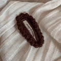 Detailed view of dark brown hand-knitted crochet hair clip with wavy textured edges - Dark Brown