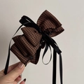 Detail view of large houndstooth bow hair clip with black satin ribbon and plastic teeth - Dark Plaid Multi-layer Coffee