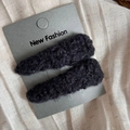 Close-up of two black plush lamb wool hair clips on display card with soft texture - Lamb Wool Triangle Pair Clips / Grey Black