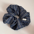 Detailed shot of a blue checkered fabric scrunchie with a Hand Made textile label - British Style Scrunchie / Blue