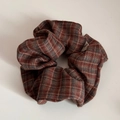 Detail of red and blue plaid scrunchie fabric with a white woven 'Made' label - British Style Scrunchie / Orange