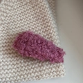 Macro shot of fluffy purple pink faux lamb wool texture on a stylish winter hair clip - Rose Red