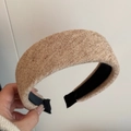 Detail of light brown knitted wide headband showing soft texture and non-slip inner lining - Beige