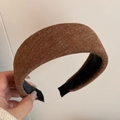 Detail of caramel knitted padded headband showing thick texture and inner lining - Brown