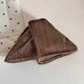 Detailed macro view of the brown velvet triangle hair claw clip with a gold metal tag - Triangle Claw Clip / Light Coffee