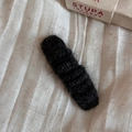 Close-up of black knitted wool hair clip with a vintage texture on beige fabric - BB Clips / Black