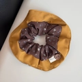 Close-up of vintage floral hair scrunchie with mustard yellow fabric and wooden button - Orange Coffee Patchwork - Side Scrunchie
