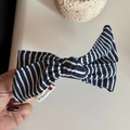Close-up of blue and white striped fabric bow hair clip with SAVING.R woven label - Navy Blue