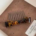 Detail of tortoise shell acetate bow hair comb with eleven silver metal teeth pins - Tortoise