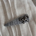 Detailed macro view of the gray plush hair clip with a sparkling rhinestone bow accent - Light Grey Bow